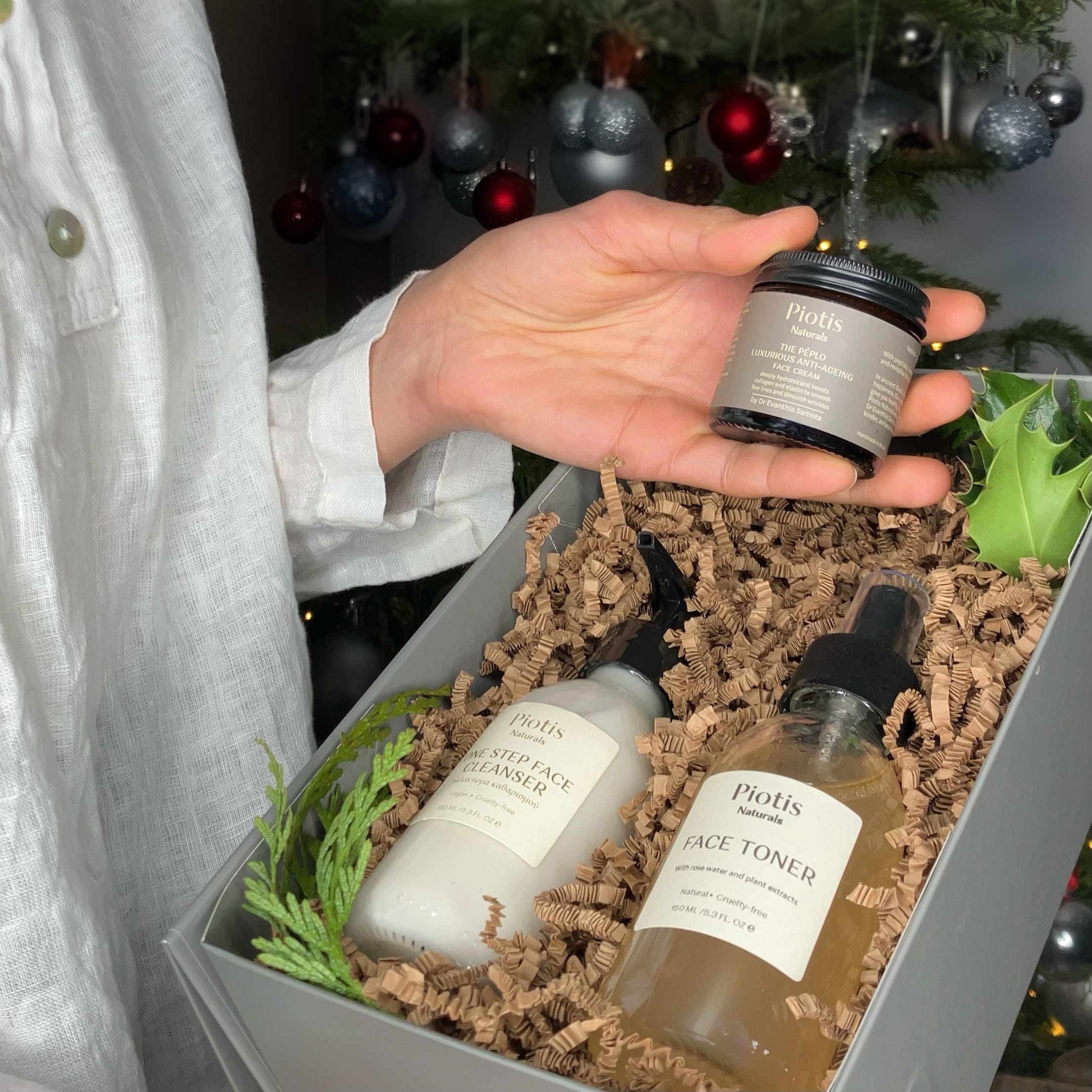 Piotis Naturals luxury Christmas gift box (small size) featuring the One Step Aloe Gel Cleanser, Natural Rosewater Face Toner, and Metastrophé Anti-Ageing Face Cream, beautifully presented with eco-friendly shredded paper and greenery. 